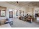 Spacious living room with modern furniture, travertine floors, and dining area at 8392 E Eagle Feather Rd, Scottsdale, AZ 85266