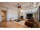 Open living room featuring fireplace, beamed ceiling, and neutral tones at 8392 E Eagle Feather Rd, Scottsdale, AZ 85266