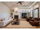 Living room with fireplace, beamed ceiling, and tile flooring at 8392 E Eagle Feather Rd, Scottsdale, AZ 85266