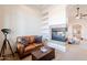 Sitting room with a comfortable leather sofa and a fireplace, creating a cozy retreat at 8392 E Eagle Feather Rd, Scottsdale, AZ 85266