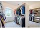 Spacious walk-in closet with custom organizers and a bright window at 8392 E Eagle Feather Rd, Scottsdale, AZ 85266