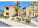 Inviting two-story condo with stairs leading to the front door and well-maintained landscaping at 8787 E Mountain View Rd # 1087, Scottsdale, AZ 85258