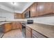 A bright kitchen features tile flooring, stainless steel appliances, plenty of cabinets, and stone countertops at 8787 E Mountain View Rd # 1087, Scottsdale, AZ 85258