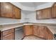 An ample kitchen offers plentiful counter space, a stainless steel dishwasher, and natural wood cabinetry at 8787 E Mountain View Rd # 1087, Scottsdale, AZ 85258