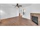 Bright living room showcasing a fireplace, laminate flooring, and a ceiling fan at 8787 E Mountain View Rd # 1087, Scottsdale, AZ 85258