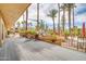 Resort-style patio with dining, grill, and lush palm trees, perfect for outdoor entertaining and relaxation at 8787 E Mountain View Rd # 1087, Scottsdale, AZ 85258