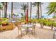 Enjoy outdoor cooking with built-in grill, seating, and views of lush tropical landscaping on the beautiful patio at 8787 E Mountain View Rd # 1087, Scottsdale, AZ 85258
