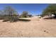 Spacious backyard with desert landscape, a small patch of turf, and hardscape areas at 9267 E Rimrock Dr, Scottsdale, AZ 85255