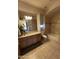 Charming bathroom with a granite vanity, decorative wallpaper and a tub-shower combination at 9267 E Rimrock Dr, Scottsdale, AZ 85255