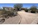 Elegant home featuring a circular driveway, desert landscaping and covered portico entry at 9267 E Rimrock Dr, Scottsdale, AZ 85255