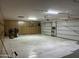 Inside of garage with storage cabinets, painted floors, and bright lighting at 9267 E Rimrock Dr, Scottsdale, AZ 85255