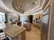 Open kitchen with a curved island, granite counters, and stainless steel appliances at 9267 E Rimrock Dr, Scottsdale, AZ 85255