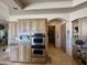 Gourmet kitchen with stainless appliances, custom cabinets, granite counters, and view to the pantry at 9267 E Rimrock Dr, Scottsdale, AZ 85255