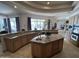 Spacious kitchen with granite counters, custom cabinets, island, and view to backyard and pool at 9267 E Rimrock Dr, Scottsdale, AZ 85255