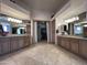 Large main bathroom with dual sinks, custom vanities, and walk-in closet at 9267 E Rimrock Dr, Scottsdale, AZ 85255