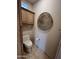 Toilet room with tile floors, toilet, cabinet, and art piece at 9267 E Rimrock Dr, Scottsdale, AZ 85255