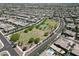 Expansive aerial shot of a residential area with a park, showcasing the neighborhood layout and amenities at 9369 W Via Montoya Dr, Peoria, AZ 85383