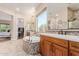 A bathroom featuring dual sinks, soaking tub, tile floors, and an open shower at 9369 W Via Montoya Dr, Peoria, AZ 85383