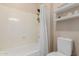 Bright bathroom featuring a toilet, shower, and wall-mounted storage shelves at 9369 W Via Montoya Dr, Peoria, AZ 85383