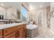 A bright bathroom featuring dual sinks, a soaking tub, tile floors, and an open-concept shower at 9369 W Via Montoya Dr, Peoria, AZ 85383