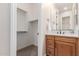 Bright bathroom featuring a vanity and sink, as well as an adjacent walk-in closet at 9369 W Via Montoya Dr, Peoria, AZ 85383