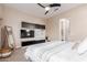 Bright bedroom featuring a media center, ensuite bathroom access, and carpeted floors at 9369 W Via Montoya Dr, Peoria, AZ 85383