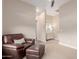 Bedroom with neutral colors and a leather lounge chair at 9369 W Via Montoya Dr, Peoria, AZ 85383