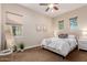 A bedroom with a ceiling fan, a large window, and a full-length mirror at 9369 W Via Montoya Dr, Peoria, AZ 85383