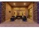 Spacious covered patio with stone accents and comfortable seating, great for outdoor living at 9369 W Via Montoya Dr, Peoria, AZ 85383
