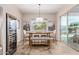 Bright dining room with a long wood table, seating six, and a beverage refrigerator at 9369 W Via Montoya Dr, Peoria, AZ 85383