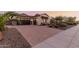Paver driveway leading to a home with a three-car garage and well-manicured landscaping at 9369 W Via Montoya Dr, Peoria, AZ 85383