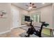 Exercise room with a Peloton stationary bike, mirrored wall, and ceiling fan at 9369 W Via Montoya Dr, Peoria, AZ 85383