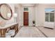 Inviting foyer with a round mirror, wood accents, and neutral decor at 9369 W Via Montoya Dr, Peoria, AZ 85383