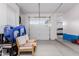 Bright garage featuring a closed garage door, seating, and beach toys at 9369 W Via Montoya Dr, Peoria, AZ 85383