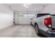Bright garage featuring a closed garage door, as well as a silver truck at 9369 W Via Montoya Dr, Peoria, AZ 85383