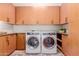 Bright laundry room featuring front load washer and dryer, countertop, and storage cabinets at 9369 W Via Montoya Dr, Peoria, AZ 85383
