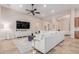 Comfortable living area with TV, bright lighting, and stylish furnishings at 9369 W Via Montoya Dr, Peoria, AZ 85383