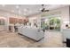 Open-concept living space with kitchen, dining, and entertainment areas under a ceiling fan at 9369 W Via Montoya Dr, Peoria, AZ 85383