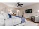 A spacious main bedroom featuring a ceiling fan, ensuite access, and stylish furnishings at 9369 W Via Montoya Dr, Peoria, AZ 85383
