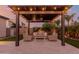 Inviting outdoor patio featuring a pergola with string lights and comfortable seating area at 9369 W Via Montoya Dr, Peoria, AZ 85383