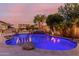 Backyard pool with captivating underwater lighting and a relaxing rock waterfall feature at 9369 W Via Montoya Dr, Peoria, AZ 85383