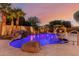 Beautiful backyard pool with rock waterfall and mature landscaping, perfect for relaxation and recreation at 9369 W Via Montoya Dr, Peoria, AZ 85383