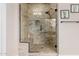 An updated tile shower featuring a glass door, built-in bench, and shower niche at 9369 W Via Montoya Dr, Peoria, AZ 85383