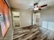 Inviting bedroom with laminate flooring, ceiling fan, walk-in closet, and access to the balcony at 10031 W Hess St, Tolleson, AZ 85353