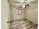 Cozy bedroom featuring stylish laminate flooring, a window with blinds, and neutral walls at 10031 W Hess St, Tolleson, AZ 85353
