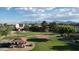 Picturesque aerial view of a community park nestled within a residential neighborhood, showcasing walking paths and mountain views at 10031 W Hess St, Tolleson, AZ 85353