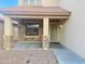 Inviting front porch with stone accents and neutral-toned siding at 10031 W Hess St, Tolleson, AZ 85353