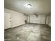 Attached garage with a roll-up door and an automatic door opener and access door to the house at 10031 W Hess St, Tolleson, AZ 85353