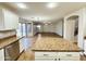 Open-concept kitchen with granite countertops and view of backyard at 10031 W Hess St, Tolleson, AZ 85353