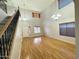 Bright living room with hardwood floors, a staircase, and a chandelier at 10031 W Hess St, Tolleson, AZ 85353